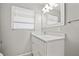 Bright bathroom featuring a modern vanity with white cabinets and a white countertop at 3218 Fauna St, Sarasota, FL 34235