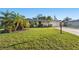 Well-maintained single-story home with a lush green lawn, mature landscaping, and a welcoming entrance at 3218 Fauna St, Sarasota, FL 34235