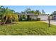 Charming house featuring a well-kept front lawn, mature landscaping, and an attached garage at 3218 Fauna St, Sarasota, FL 34235