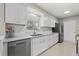 Modern kitchen with stainless steel appliances, white cabinetry, and beautiful quartz countertops at 3218 Fauna St, Sarasota, FL 34235