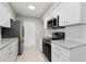 Updated kitchen features white cabinets, stainless steel appliances, and lots of natural light at 3218 Fauna St, Sarasota, FL 34235