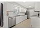 Bright kitchen features white cabinets, stainless steel appliances, and gray countertops at 3218 Fauna St, Sarasota, FL 34235
