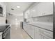 Updated kitchen features white cabinets, stainless steel appliances, and gray countertops at 3218 Fauna St, Sarasota, FL 34235