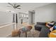 Spacious living area with a comfy sofa, adjacent kitchen, and large windows filling the room with light at 3218 Fauna St, Sarasota, FL 34235