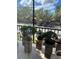 Balcony displaying bonsai trees and offering serene views of the community at 3265 Beneva Rd # 202, Sarasota, FL 34232