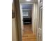 Hallway view into bedroom with wood flooring and a black bedspread at 3265 Beneva Rd # 202, Sarasota, FL 34232