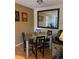 Dining area featuring a glass-top table with black chairs and a large framed mirror at 3265 Beneva Rd # 202, Sarasota, FL 34232