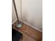 Shows a floor lamp on wood-look flooring with a white baseboard at 3265 Beneva Rd # 202, Sarasota, FL 34232