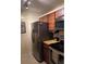 View of a kitchen with stainless steel refrigerator and rich wood-tone cabinetry at 3265 Beneva Rd # 202, Sarasota, FL 34232