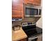 The kitchen features updated appliances and wood grain finish cabinetry at 3265 Beneva Rd # 202, Sarasota, FL 34232