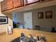 A well-lit kitchen view through to dining area with a stainless steel sink and faucet at 3265 Beneva Rd # 202, Sarasota, FL 34232