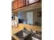 Well-lit kitchen features a double stainless steel sink and serving hatch at 3265 Beneva Rd # 202, Sarasota, FL 34232
