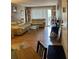 Spacious living room with two sofas, a glass coffee table, and balcony access at 3265 Beneva Rd # 202, Sarasota, FL 34232