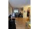 Open-concept living and dining area with wooden floors and natural light at 3265 Beneva Rd # 202, Sarasota, FL 34232