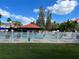 Community pool view featuring a red roof pavilion and white picket fence in a well-maintained area at 3265 Beneva Rd # 202, Sarasota, FL 34232