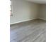 Bright and airy bedroom showcasing durable laminate floors and a large window for natural light at 3320 Jackson Dr, Holiday, FL 34691