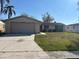 Charming single-story home featuring an attached two-car garage and well-maintained front lawn at 3320 Jackson Dr, Holiday, FL 34691