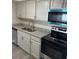 Modern kitchen features stainless steel appliances, granite countertops, and ample cabinet space at 3320 Jackson Dr, Holiday, FL 34691