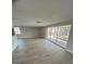 Bright living room with wood-look flooring and sliding doors to screened porch at 3320 Jackson Dr, Holiday, FL 34691
