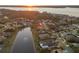 Aerial view of a home with a pond and lake view showcasing the surrounding neighborhood at 3830 Moreno Dr, Palm Harbor, FL 34685