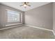 Bedroom features neutral carpeting, ceiling fan, and a large window with built-in shelf at 3830 Moreno Dr, Palm Harbor, FL 34685