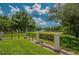Scenic Lansbrook Lakefront Park entrance with lush lawns, trees, and a glimpse of the lake at 3830 Moreno Dr, Palm Harbor, FL 34685