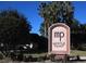 Community sign for Myrtle Point showcasing the neighborhood entrance with lush landscaping at 3830 Moreno Dr, Palm Harbor, FL 34685