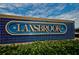 Community sign for Lansbrook, featuring blue tile and gold lettering, with manicured shrubs at 3830 Moreno Dr, Palm Harbor, FL 34685