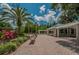 Expansive outdoor space featuring a covered pavilion, benches, and beautiful landscaping with palm trees at 3830 Moreno Dr, Palm Harbor, FL 34685