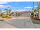 Attractive home with a red tile roof, mature palm trees, and a wide driveway leading to a three-car garage at 3830 Moreno Dr, Palm Harbor, FL 34685