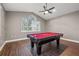 Game room with pool table, laminate flooring, vaulted ceiling, and bright, natural light at 3830 Moreno Dr, Palm Harbor, FL 34685