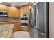 Bright kitchen with stainless steel appliances, granite countertops, and custom wood cabinets at 3830 Moreno Dr, Palm Harbor, FL 34685