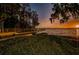 Scenic lake view at sunset with a wooden dock, offering tranquility and natural beauty at 3830 Moreno Dr, Palm Harbor, FL 34685