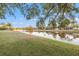 Picturesque waterfront view with the calm lake reflecting the sky and trees at 3830 Moreno Dr, Palm Harbor, FL 34685