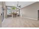 Open living room featuring high ceilings, large windows, fireplace, and neutral paint at 3830 Moreno Dr, Palm Harbor, FL 34685