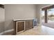 Living room features a custom built-in cabinet with wine cooler, tile floors and neutral paint at 3830 Moreno Dr, Palm Harbor, FL 34685