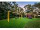 A spacious community playground with swings and slides on artificial grass at 3830 Moreno Dr, Palm Harbor, FL 34685