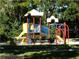 Community playground with slides, climbing structures, and seating at 3830 Moreno Dr, Palm Harbor, FL 34685