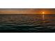 A stunning sunset over the water creates a colorful sky at 3830 Moreno Dr, Palm Harbor, FL 34685