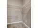 Empty walk-in closet with carpeted floors and basic wire shelving system at 3830 Moreno Dr, Palm Harbor, FL 34685