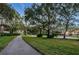 A scenic walking path meanders through a verdant landscape at 3830 Moreno Dr, Palm Harbor, FL 34685