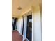 Tiled balcony with glass door access, showing light fixture on the ceiling at 4801 Osprey S Dr # 209, St Petersburg, FL 33711