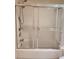 The bright bathroom showcases a shower-tub combo with sliding glass doors and chrome fixtures at 4801 Osprey S Dr # 209, St Petersburg, FL 33711