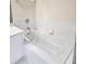 Bright white bathroom with tile surround on the bathtub at 4801 Osprey S Dr # 209, St Petersburg, FL 33711