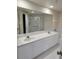 Bathroom with double sink vanity, large mirror, walk-in shower and tile flooring at 4801 Osprey S Dr # 209, St Petersburg, FL 33711