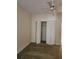 Bright bedroom with neutral walls, carpet flooring, a fan, and a closet with folding doors at 4801 Osprey S Dr # 209, St Petersburg, FL 33711