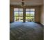 A bedroom with a ceiling fan and large windows overlooking greenery at 4801 Osprey S Dr # 209, St Petersburg, FL 33711