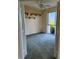 Inviting bedroom with a ceiling fan, neutral walls, carpet flooring, and a sliding glass door to the balcony at 4801 Osprey S Dr # 209, St Petersburg, FL 33711