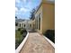 Inviting clubhouse exterior with brick pathway, pergola, and manicured landscaping at 4801 Osprey S Dr # 209, St Petersburg, FL 33711