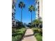 Serene courtyard view with lush greenery and distant ocean vista at 4801 Osprey S Dr # 209, St Petersburg, FL 33711